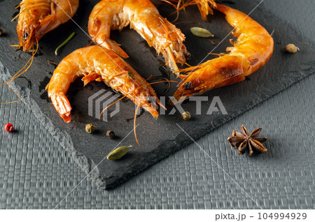 Boiled shrimp on a gray serving board served for dessert after dinner 104994929