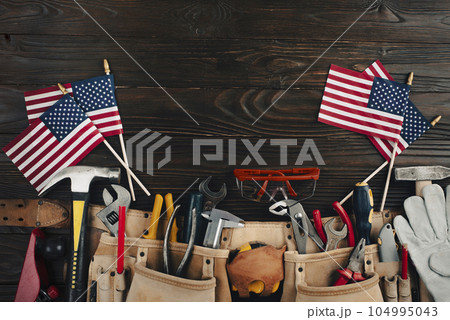Labor day banner mockup of tools toolbelt and us flag on wooden background 104995043