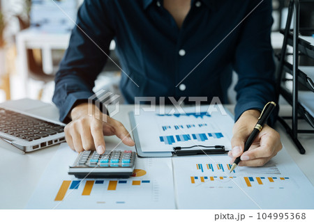 Male businessman and financial concepts about office work. Analysts discuss business with tablet and calculator as a tool. 104995368