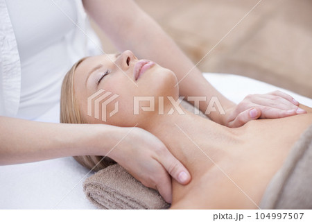 Hands of masseuse, woman getting neck massage in spa and wellness with peace, tranquility and holistic treatment. Stress relief, zen and female person at luxury resort with self care and body healing 104997507