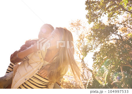 Love, piggyback and mother with girl child in a park happy, hug and bonding outdoor together. Smile, parent and family embrace in nature, laughing and having fun while walking and enjoying a holiday Love, piggyback and mother with girl child in a park happy, hug and bonding outdoor together. Smile, parent and family embrace in nature, laughing and having fun while walking and enjoying a holiday 104997533