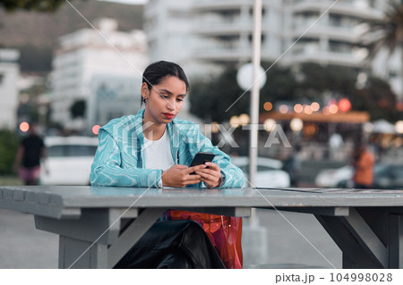 Edgy, sad and lonely woman texting on social media dating app on a phone and looking serious, depressed or bored outside in an urban city. A single girl posting about her bad emotional breakup online Edgy, sad and lonely woman texting on social media dating app on a phone and looking serious, depressed or bored outside in an urban city. A single girl posting about her bad emotional breakup online 104998028