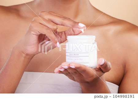 Hands, skincare or woman with cream product for beauty or wellness isolated on studio background. Body cosmetics, self care zoom or girl with facial moisturizer or dermatology lotion for anti aging 104998191