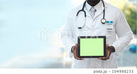 Hands, tablet and green screen with doctor in hospital for promotion, mockup space and branding. Man, medic and tech touchscreen for telehealth mock up, app and logo in clinic for healthcare promo Hands, tablet and green screen with doctor in hospital for promotion, mockup space and branding. Man, medic and tech touchscreen for telehealth mock up, app and logo in clinic for healthcare promo 104998233