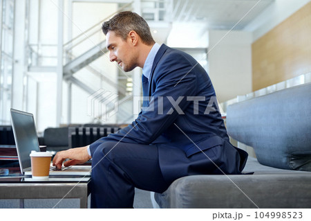 Thinking, corporate or businessman on laptop for invest strategy, finance growth or financial review. Coffee, focus or employee on sofa for investment trading, typing email or economy data research 104998523