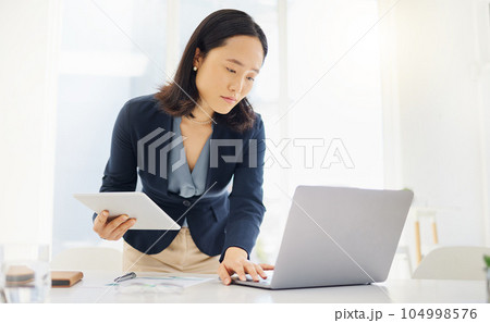 Tablet, focus and laptop with business woman in office for planning, online report and email. Technology, communication and connection with asian female employee for corporate, idea and review 104998576