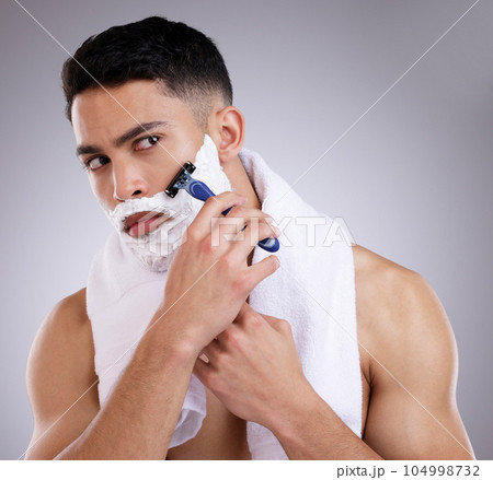 Beauty, shaving and foam with man in studio for hair removal, grooming and skincare. Cosmetics, self care and shower with face of male model on gray background for cleaning, razor blade and product 104998732