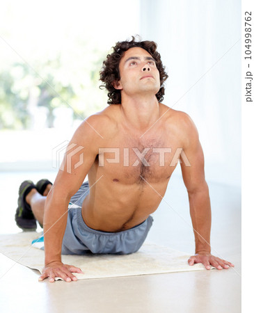 Yoga, man and cobra stretch in home for health, wellness and flexibility in house. Pilates, stretching and male person, yogi or athlete training, holistic workout and exercising for fitness on mat. Yoga, man and cobra stretch in home for health, wellness and flexibility in house. Pilates, stretching and male person, yogi or athlete training, holistic workout and exercising for fitness on mat. 104998762