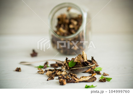 dried forest edible mushrooms on wooden table 104999760