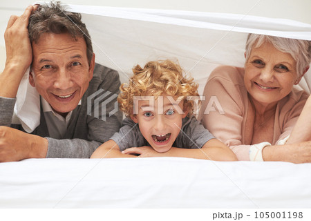 Portrait, grandparents or excited boy in bedroom to relax together for bonding in Australia with love or care. Morning, faces or happy grandmother with funny kid or old man to enjoy quality bed time Portrait, grandparents or excited boy in bedroom to relax together for bonding in Australia with love or care. Morning, faces or happy grandmother with funny kid or old man to enjoy quality bed time 105001198