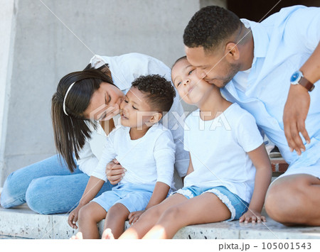Plenty of kisses for baby cheeks. Shot of a beautiful family relaxing outside and dipping their feet in a pool. Plenty of kisses for baby cheeks. Shot of a beautiful family relaxing outside and dipping their feet in a pool. 105001543