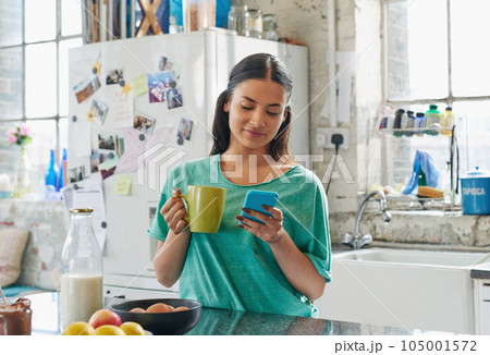 Phone, coffee or woman in house kitchen for communication or social network on media app in morning. Tea, smile or happy girl on smartphone reading social media news, networking or mobile internet 105001572