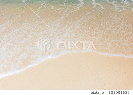 Sea waves bubbles on the sandy beach 105001685