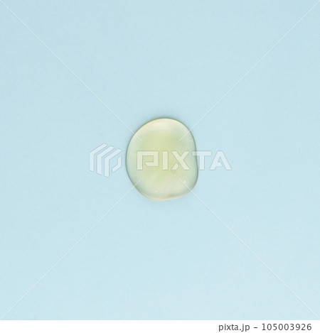 Drop of transparent face and body cream on a blue background 105003926