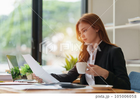 Accountant woman working on laptop and do document, tax, exchange, research, accounting and Financial advisor concept Accountant woman working on laptop and do document, tax, exchange, research, accounting and Financial advisor concept 105006058