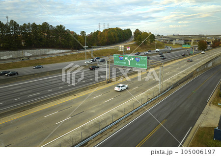 American freeway intersection with fast driving cars and trucks. View from above of USA transportation infrastructure 105006197
