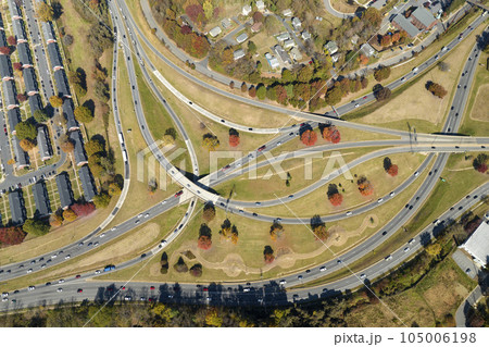 American freeway intersection in Asheville, North Carolina with fast driving cars and trucks in autumnal season. View from above of USA transportation infrastructure American freeway intersection in Asheville, North Carolina with fast driving cars and trucks in autumnal season. View from above of USA transportation infrastructure 105006198