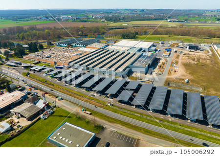 Aerial view of solar panels installed over parking lot with parked cars for effective generation of clean energy 105006292