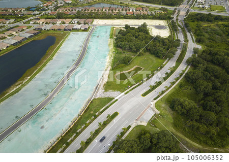 Aerial view of real estate development with tightly located family houses under construction in Florida closed suburban area. Concept of growing american suburbs 105006352