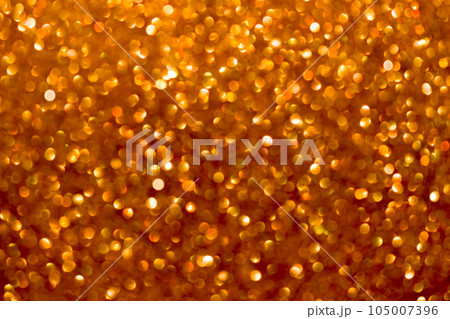 An abstract gold background with sparkle lights and bokeh. Gold blurred light. An abstract gold background with sparkle lights and bokeh. Gold blurred light. 105007396