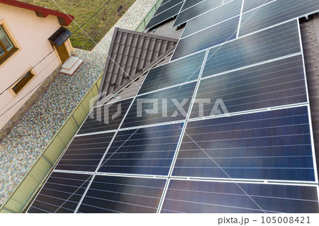 Aerial view building roof with rows of blue solar photovoltaic panels for producing clean ecological electric energy. Renewable electricity with zero emission concept 105008421