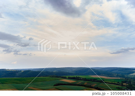 Aerial landscape view of green cultivated agricultural fields with growing crops on bright summer day 105008431