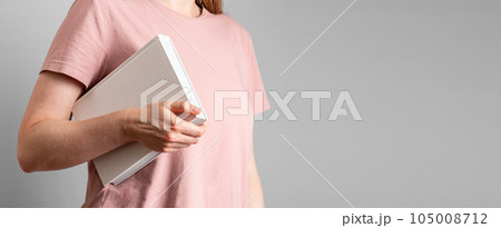 Hand holding abstract closed paper book. Banner background with copy space for text Hand holding abstract closed paper book. Banner background with copy space for text 105008712