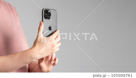 Berlin, Germany June 15 2023 Hand holding mobile phone, taking photo on smartphone camera. Banner background 105008761
