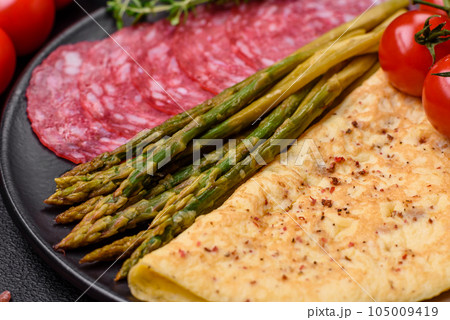 Delicious nutritious breakfast consisting of asparagus, scrambled eggs, salt, spices and herbs Delicious nutritious breakfast consisting of asparagus, scrambled eggs, salt, spices and herbs 105009419
