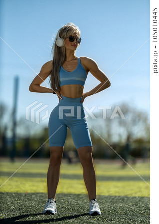 blonde athletic girl stands on the football field 105010445