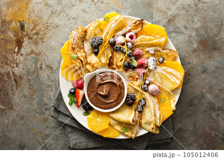 Thin crepes with berries and fruit 105012406