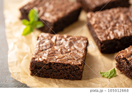 Freshly baked brownies on a parchment paper 105012668