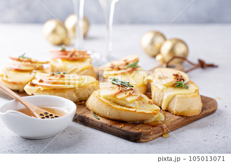New Years Eve party appetizer, pear and brie crostini 105013071