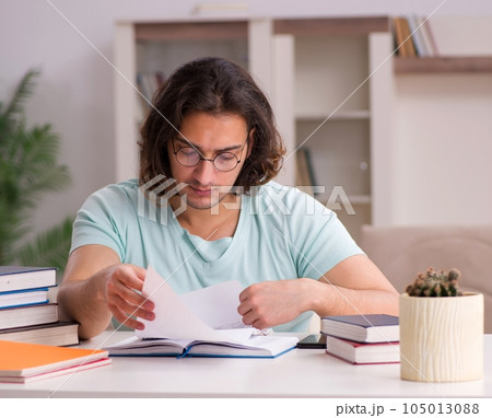 Young male student preparing for exams at home Young male student preparing for exams at home 105013088