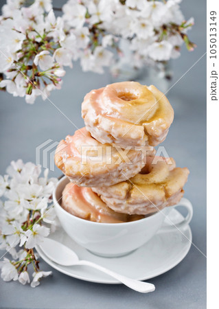 Vanilla and lavender donuts stacked in a cup 105013149