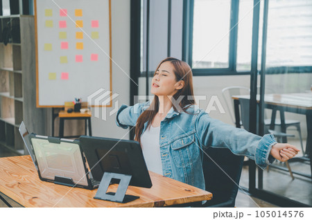 Female programmers are stretching oneself and relaxing after working and planning to work on programming, software coding and web design. Concept technology development. Female programmers are stretching oneself and relaxing after working and planning to work on programming, software coding and web design. Concept technology development. 105014576