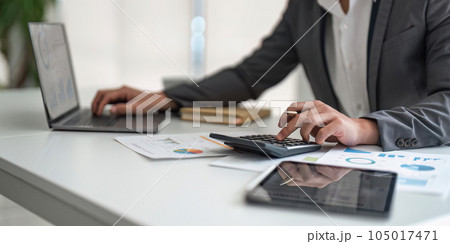 Young asian business man audit analysis graph company budget report, assigned accounts receivable, production control, operational audit, cost plus pricing 105017471