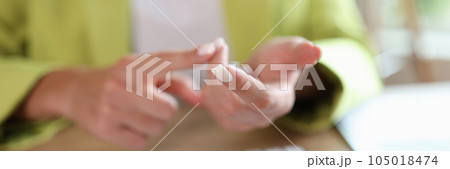 Woman counts on her fingers while sitting at table with computer keyboard. Woman counts on her fingers while sitting at table with computer keyboard. 105018474