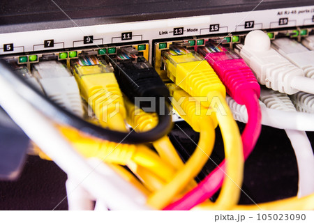 colorful patch cables connected to switch - high speed internet concept colorful patch cables connected to switch - high speed internet concept 105023090