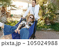 Happy woman sitting inside of shopping trolley and man pushing shopping cart 105024988