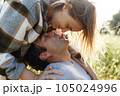 Close up portrait man and woman laughing together.Romantic affectionate couple on a holiday.Couple embracing and smiling. Sunset sunshine 105024996