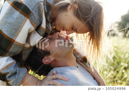 Close up portrait man and woman laughing together.Romantic affectionate couple on a holiday.Couple embracing and smiling. Sunset sunshine Close up portrait man and woman laughing together.Romantic affectionate couple on a holiday.Couple embracing and smiling. Sunset sunshine 105024996