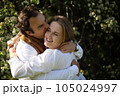 Close up portrait man and woman laughing together.Romantic affectionate couple on a holiday.Couple embracing and smiling. Sunset sunshine 105024997