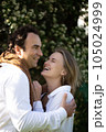 Close up portrait man and woman laughing together.Romantic affectionate couple on a holiday.Couple embracing and smiling. Sunset sunshine 105024999