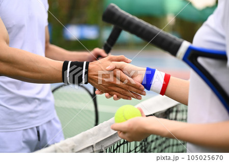 Tennis players shaking hands after the match. Sport, training, competition and active life concept Tennis players shaking hands after the match. Sport, training, competition and active life concept 105025670