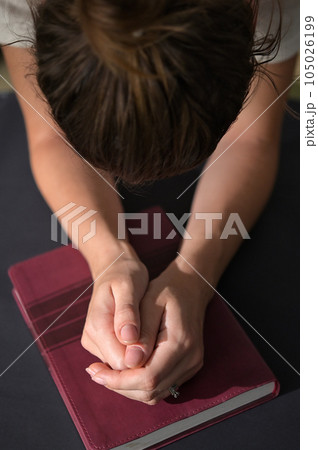 Christian Woman Hands Folded On Holy Bible Are Pray And Worship 105026199