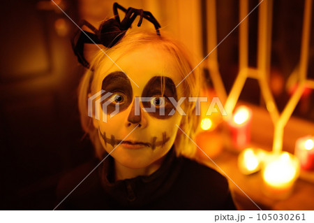 Little child in scary skeleton costume at Halloween celebration party. The child is ready for trick or treat on Halloween night. The kid scares. Little child in scary skeleton costume at Halloween celebration party. The child is ready for trick or treat on Halloween night. The kid scares. 105030261