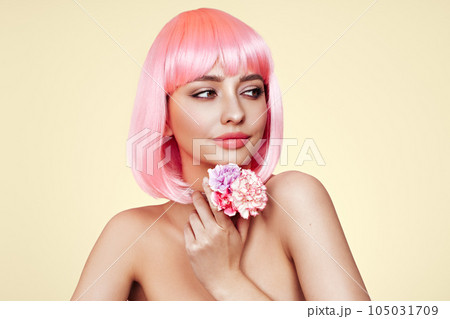 Beauty model portrait with pink hair and carnation flowers 105031709