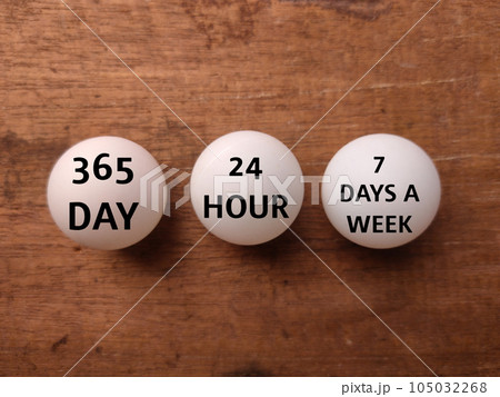 Ping pong ball with the word 365 DAY 24 HOUR 7 DAYS A WEEK on a wooden background Ping pong ball with the word 365 DAY 24 HOUR 7 DAYS A WEEK on a wooden background 105032268