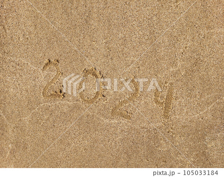 The numbers 2024 are written on the sandy beach. The concept of the new year. The numbers 2024 are written on the sandy beach. The concept of the new year. 105033184